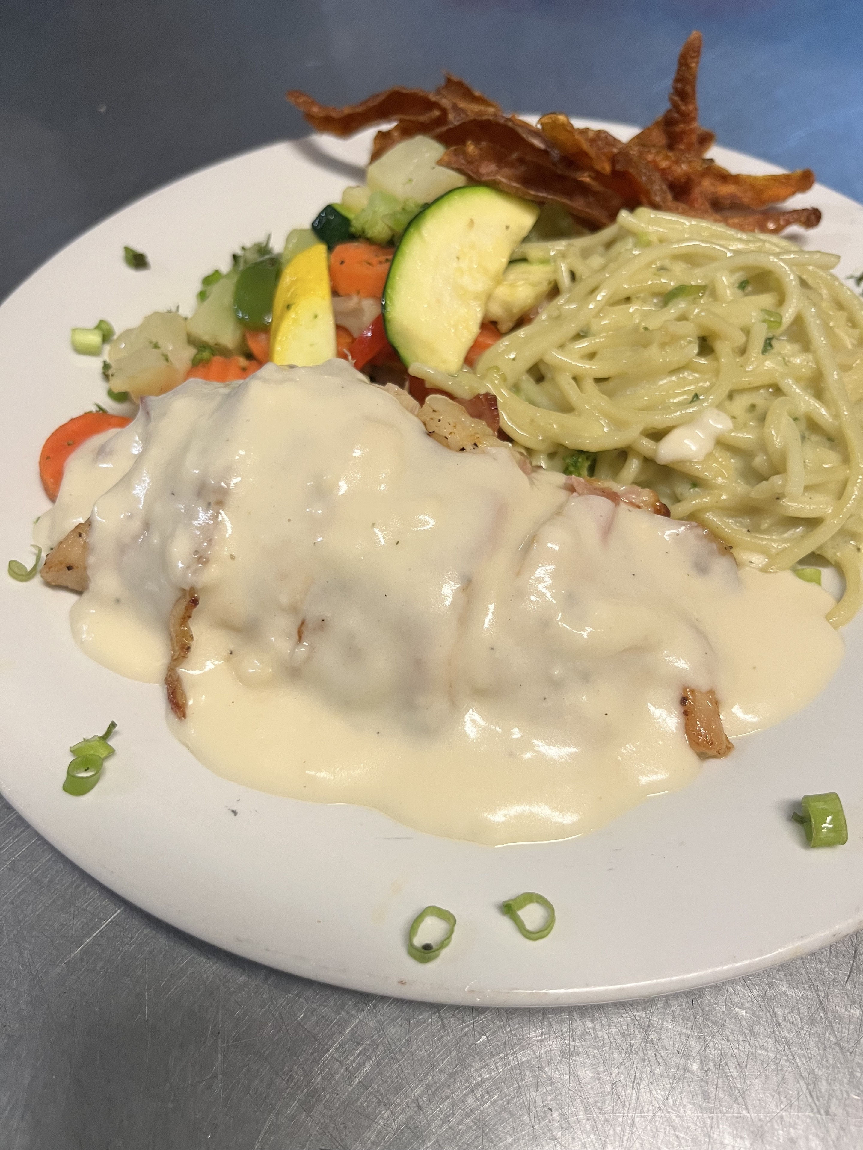 Freshly prepared catered entree with pasta and vegetables